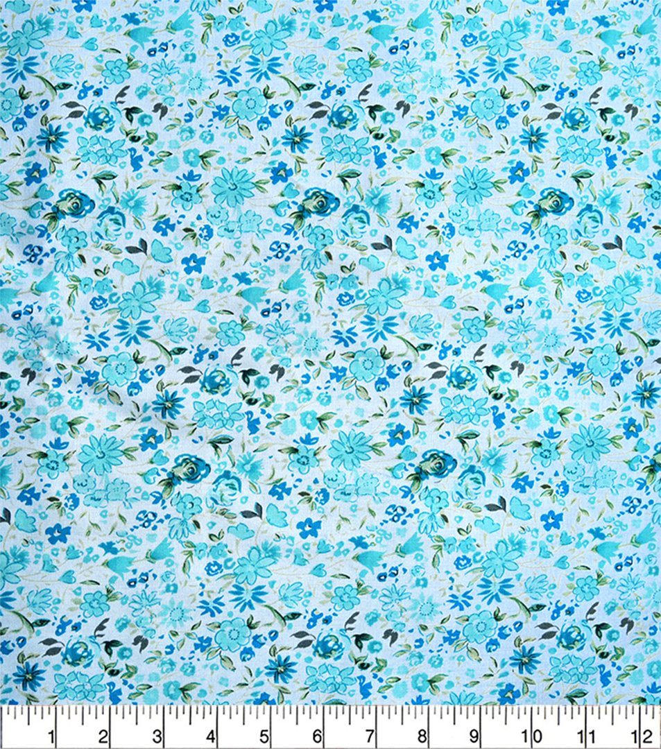 Blue floral pattern fabric with a ruler for scale