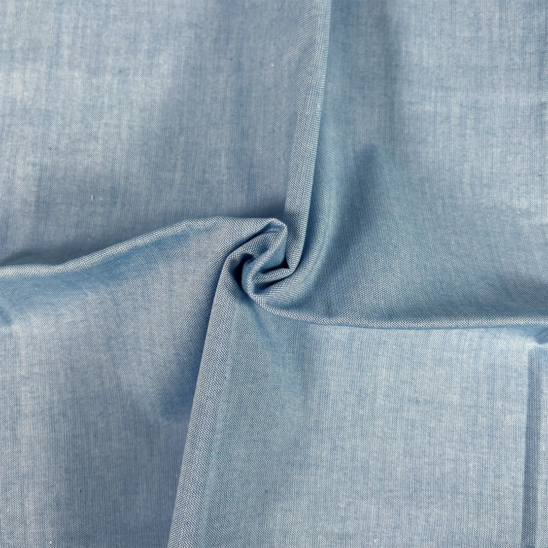 Close-up of blue fabric with a subtle pattern