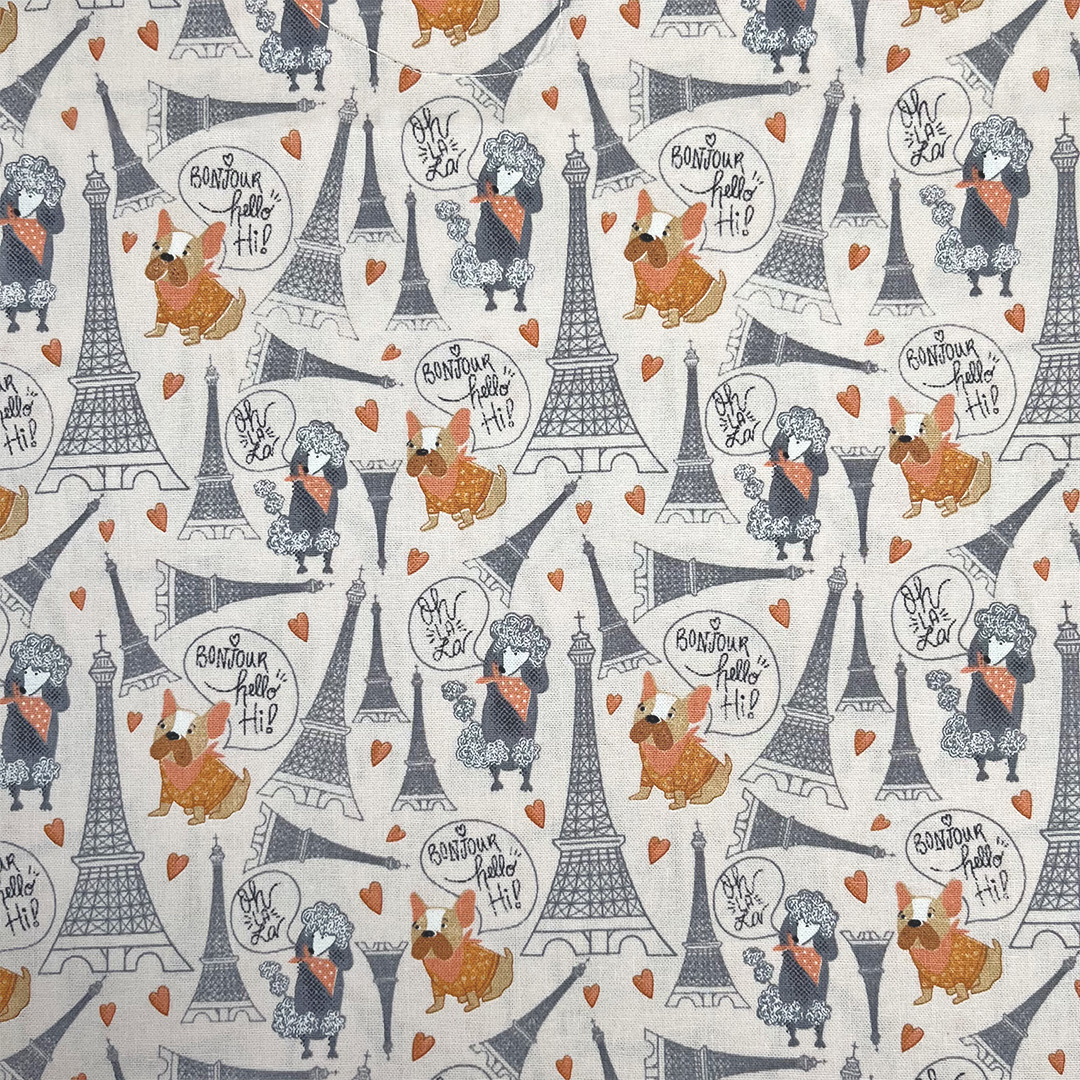Patterned fabric with Eiffel Tower, dogs, and text on a white background