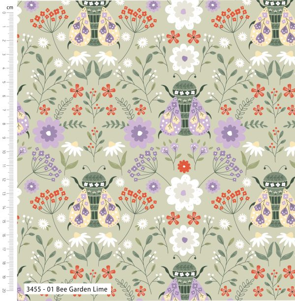 Fabric with a pattern of bees and flowers on a light green background, featuring a ruler for scale.