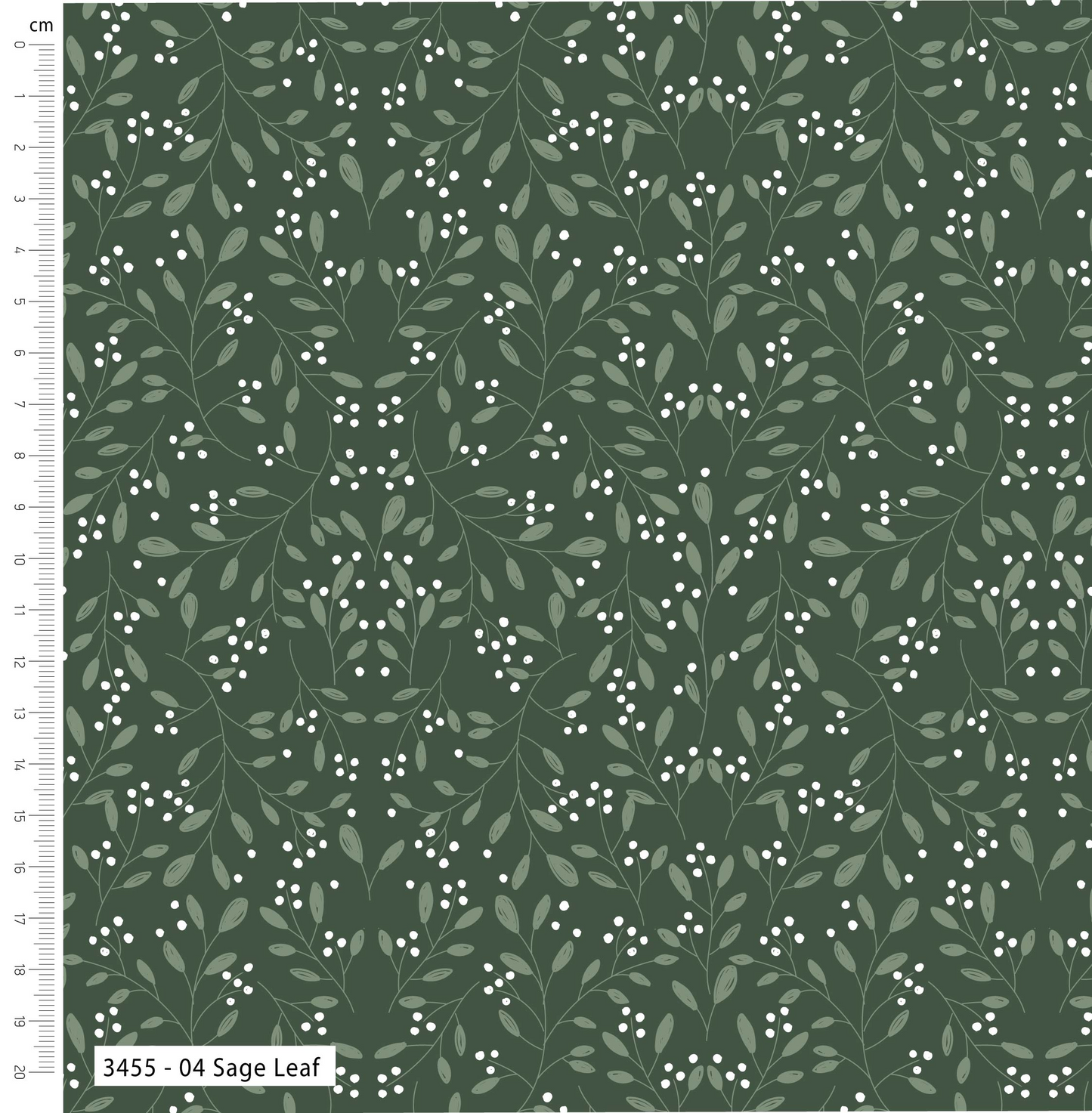 Fabric with leaf pattern on a green background, featuring a ruler for scale.