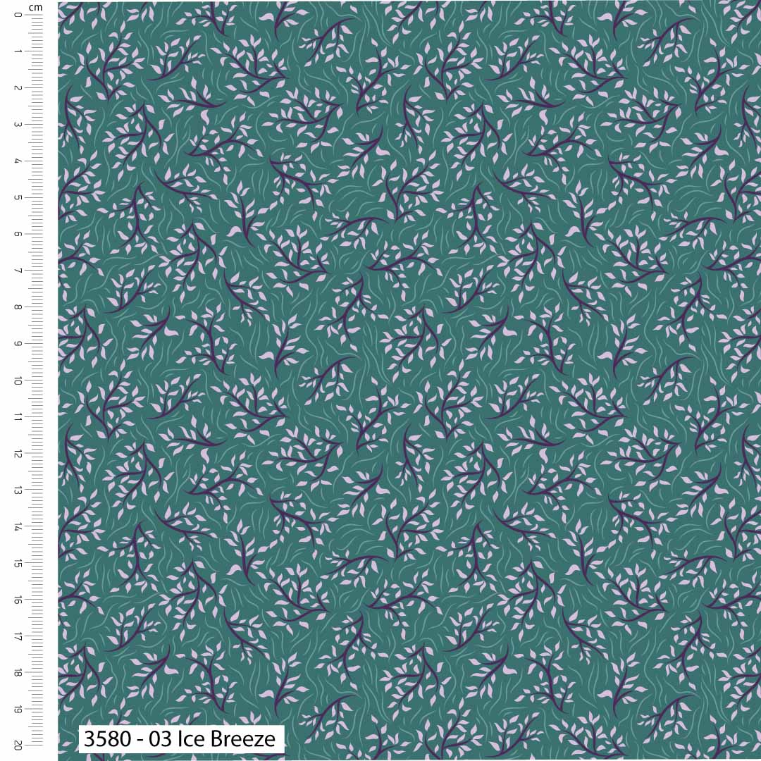 Fabric with a leaf pattern on a green background, featuring a ruler for scale.