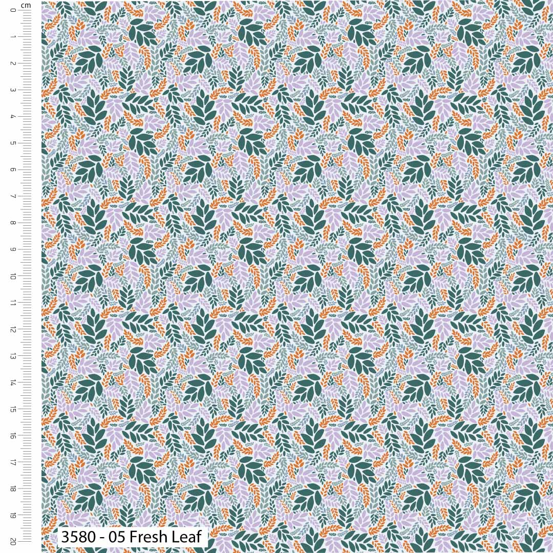 Fabric with a leaf pattern and a ruler for scale on the left side.
