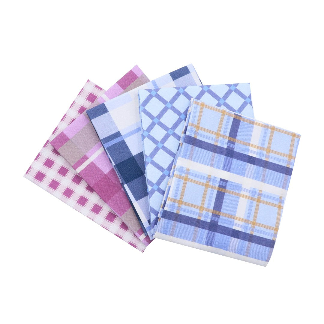 Set of four plaid patterned napkins on a white background