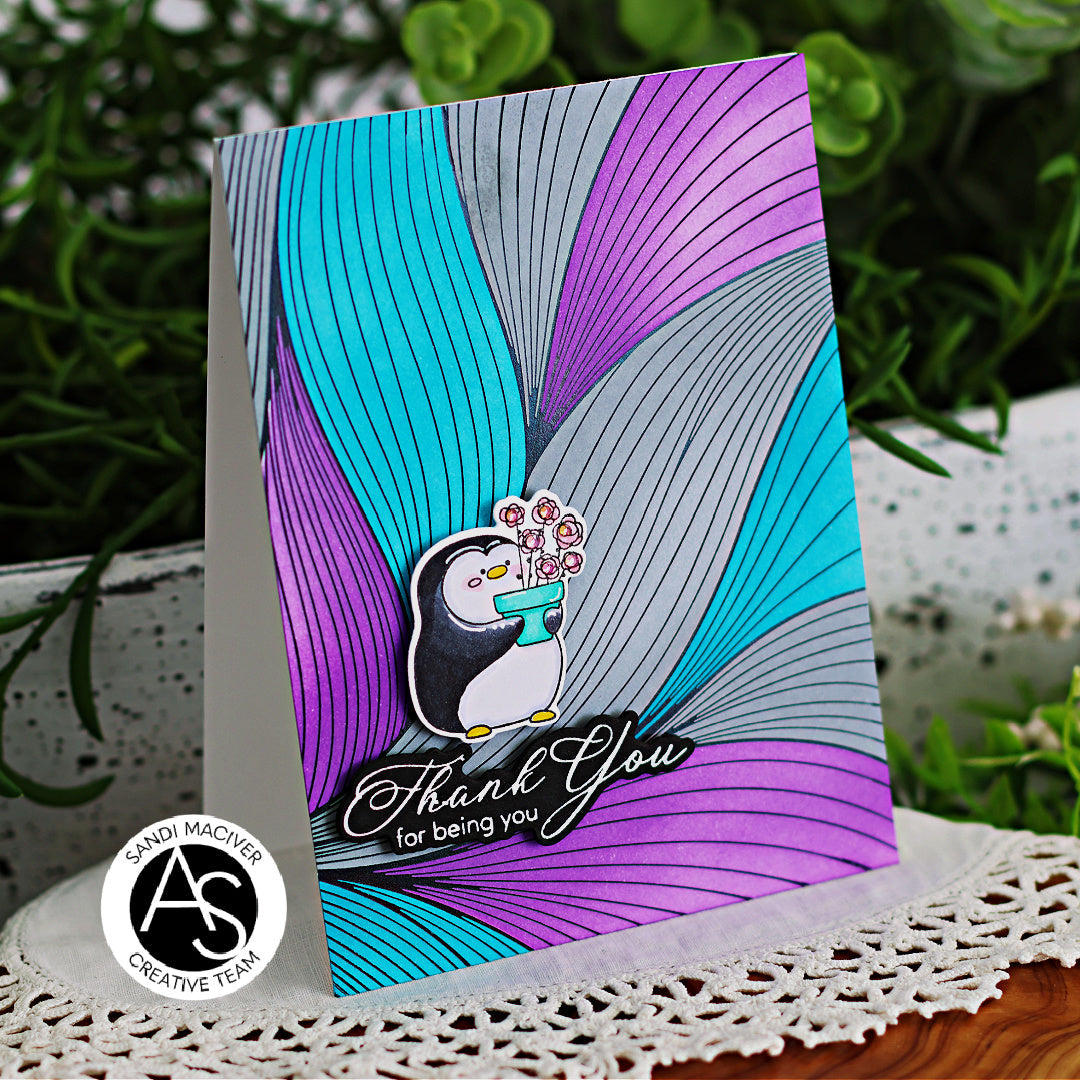 Greeting card with penguin design and 'Thank You' text on a colorful background, featuring Sandi Maciver Creative Team logo.