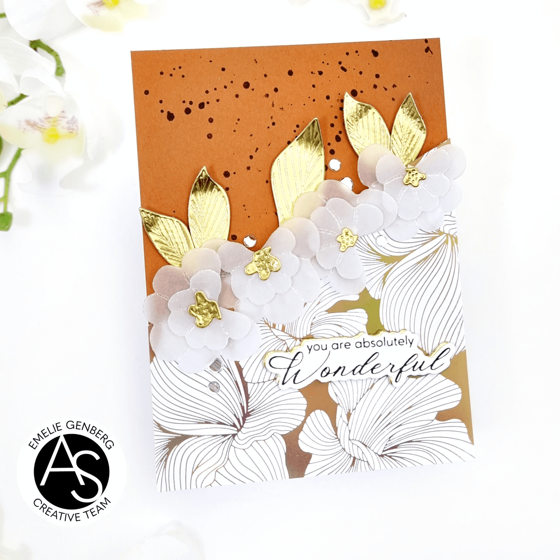 Card with white flowers and gold accents on an orange background, featuring the text 'you are absolutely wonderful'.
