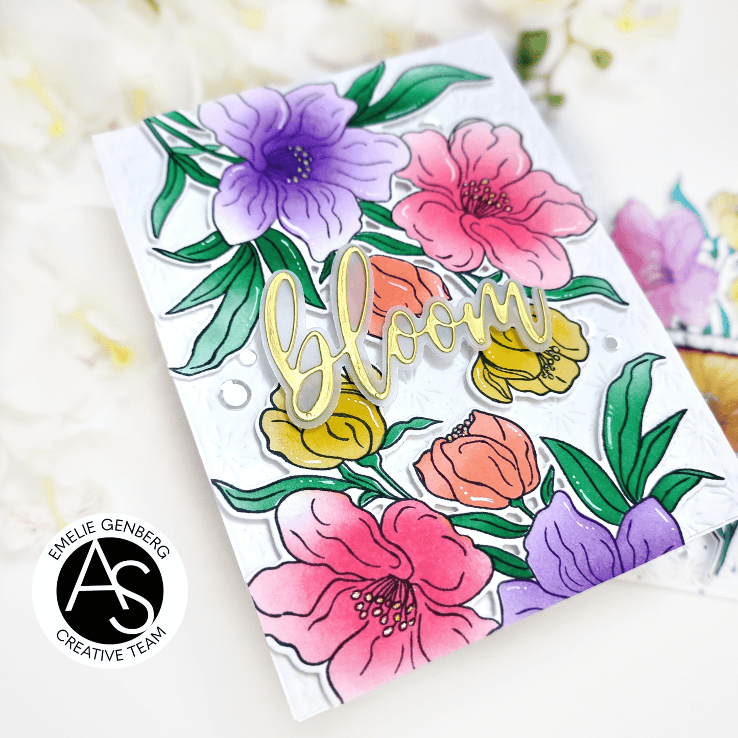 Clear stamp set with colorful floral designs and the word 'bloom' on a white background.