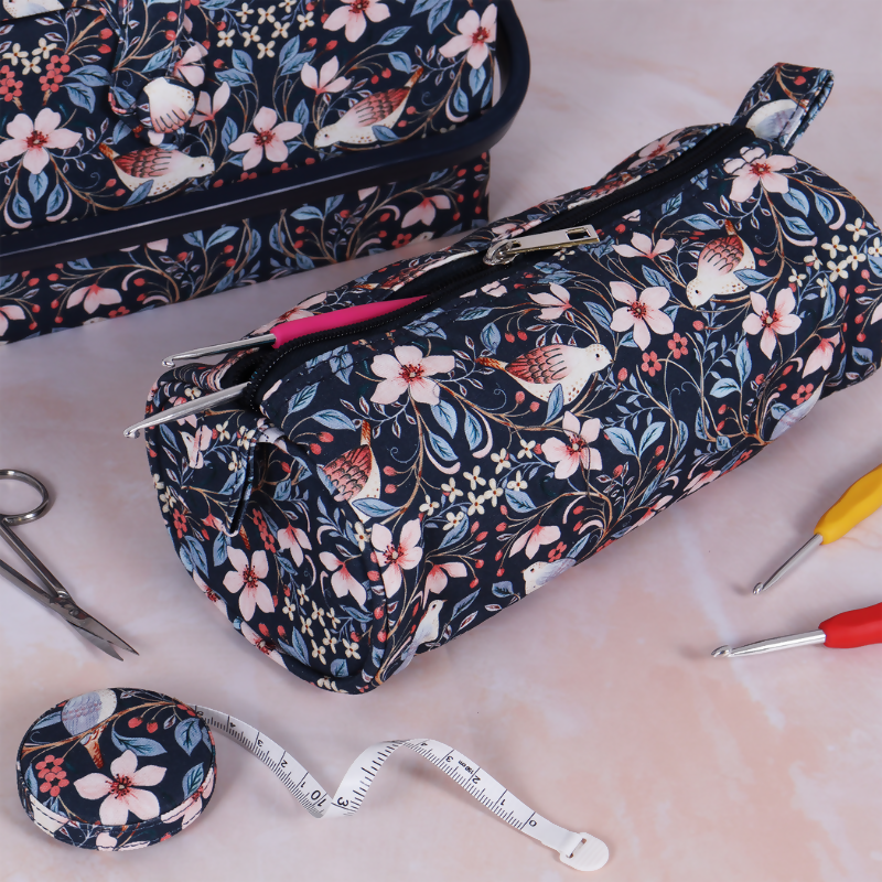 Hand carrying Blossom Birds Crochet Case with crochet hooks inside