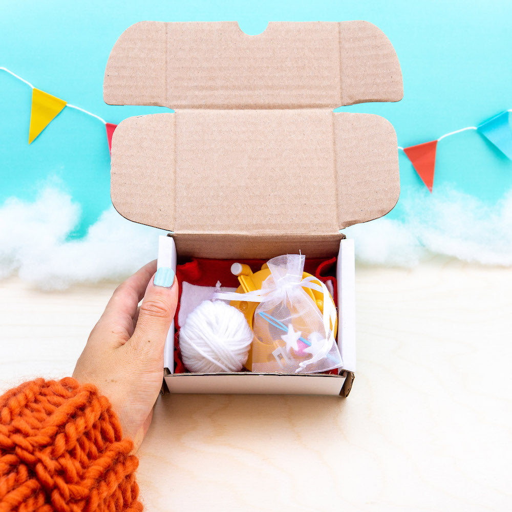Open cardboard box with items on a light blue background