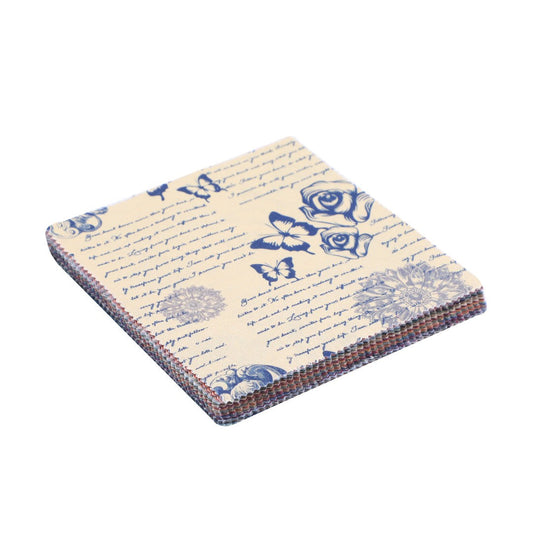 Stack of paper with blue floral and butterfly designs on a beige background