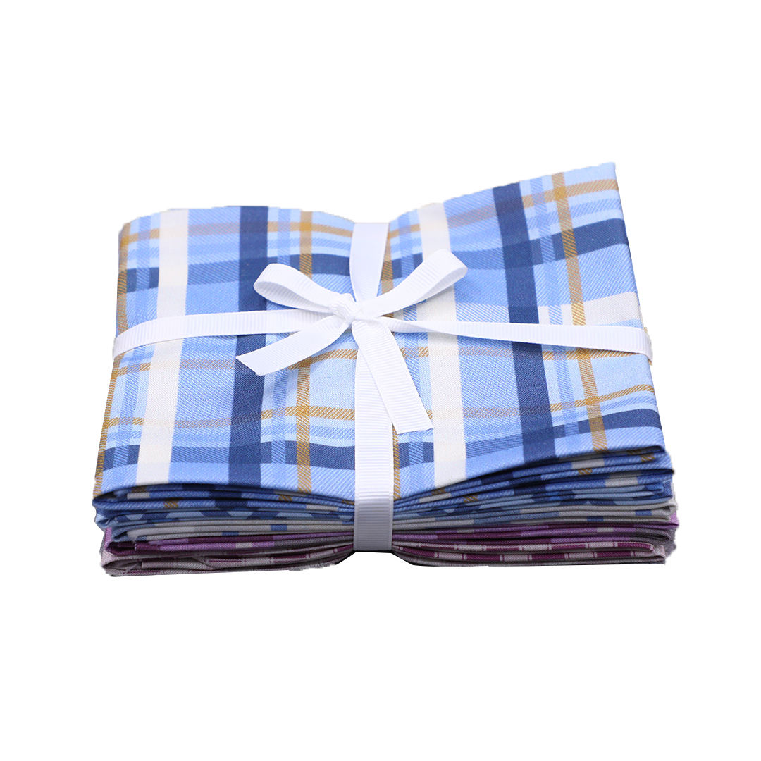 Plaid fabric roll with a white ribbon on a white background