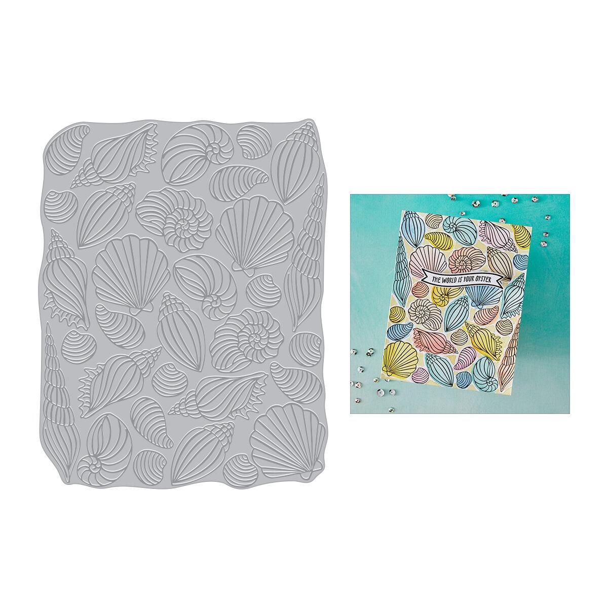 Gray embossing folder with shell pattern and a card with colorful shell design on a white background