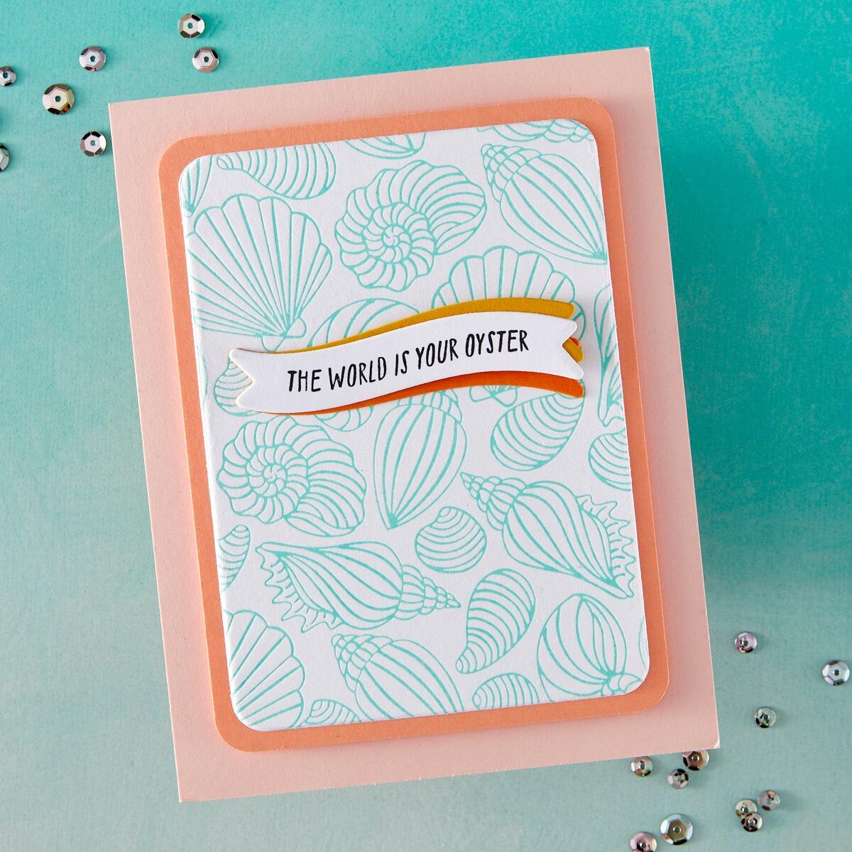Card with shell pattern and 'The World is Your Oyster' text on a teal background
