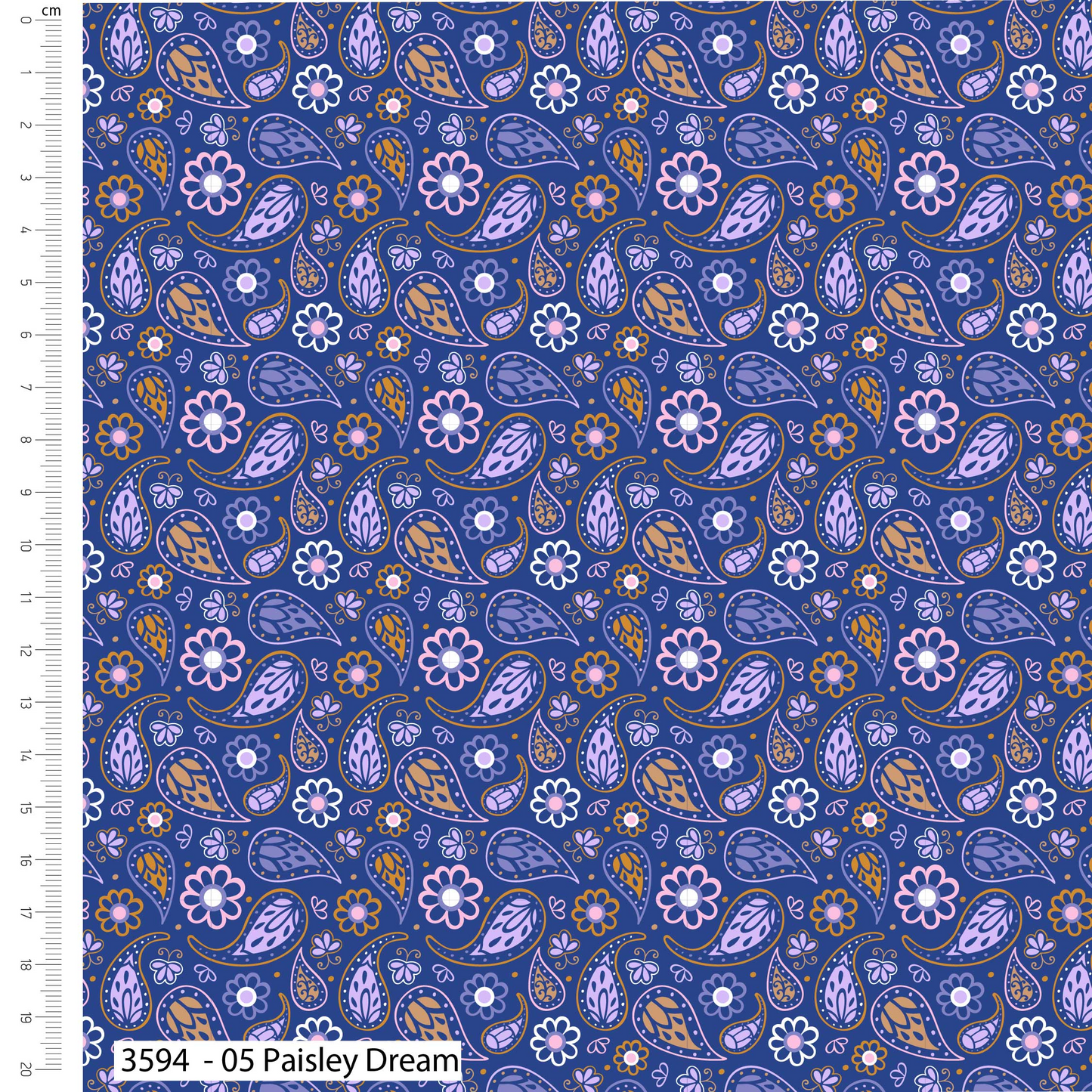 Patterned fabric with paisley and floral designs on a blue background, with a ruler on the left side.