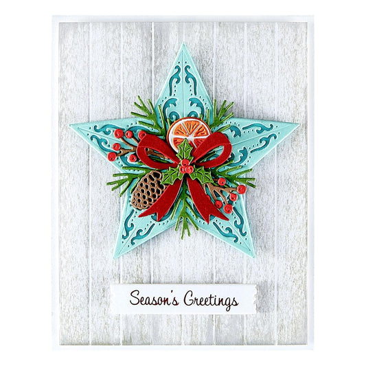 Decorative Christmas card with a star design, red bow, and festive elements on a white wooden background.