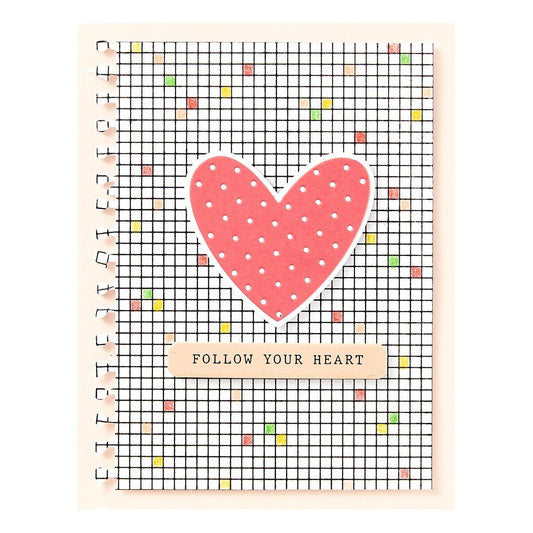 Card with a pink heart and 'Follow Your Heart' text on a grid background