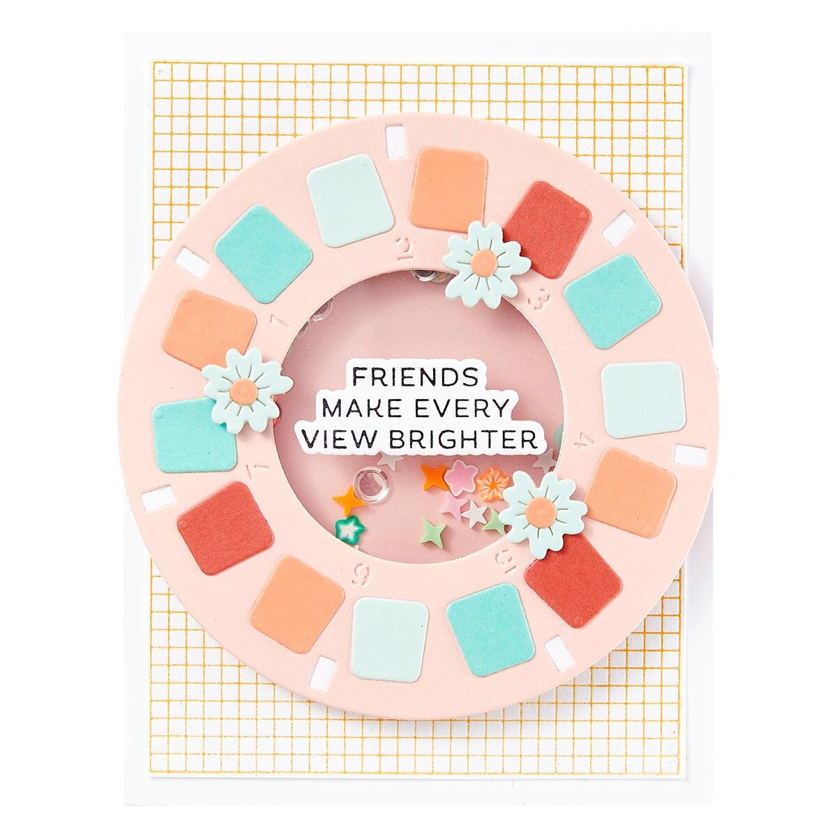 Decorative wreath with colorful squares and flowers on a yellow grid background