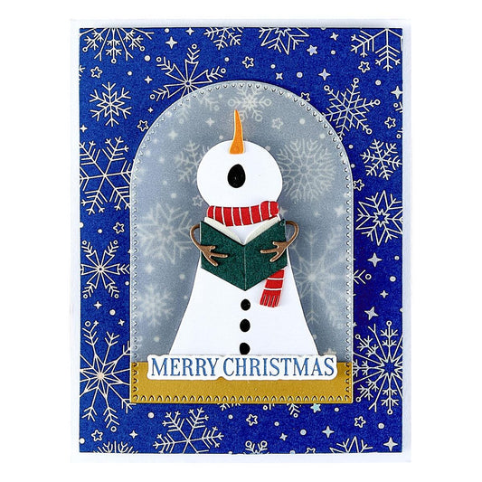 Spellbinders Christmas card with a snowman design on a blue background with snowflakes.
