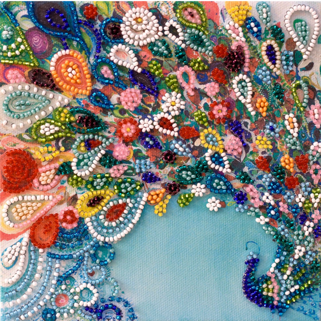 A finished, beaded peacock with a colourful tail from the Abris Art kit.