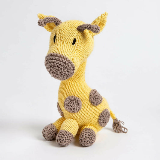 Knitted giraffe toy on a white background