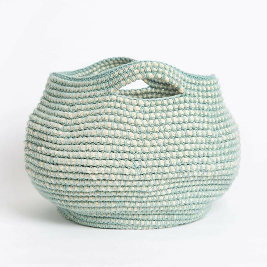 Teal woven basket with handles on a white background