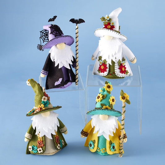Set of colorful gnome figurines with decorative hats on a blue background