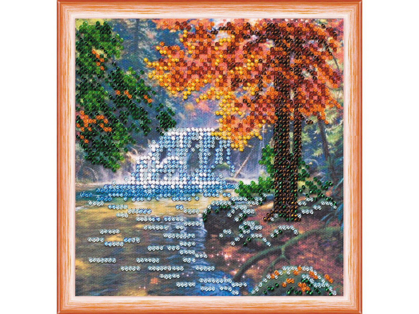 Embroided scene with autumn tree, bridge, and water body.