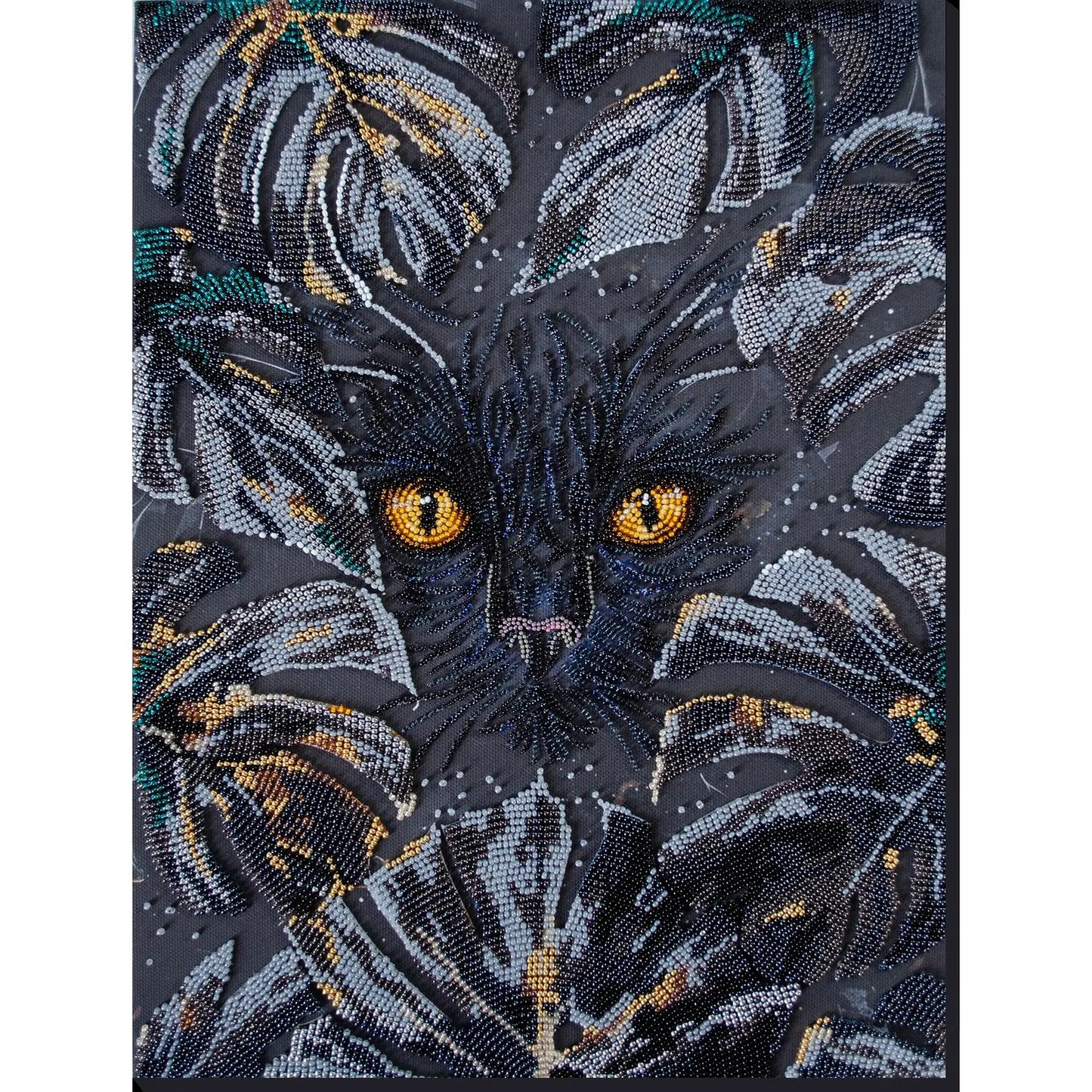 Embroidered design of a cat's face with intricate details on a dark background