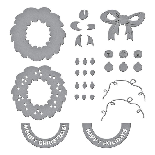 Set of Christmas-themed metal cutting dies on a white background