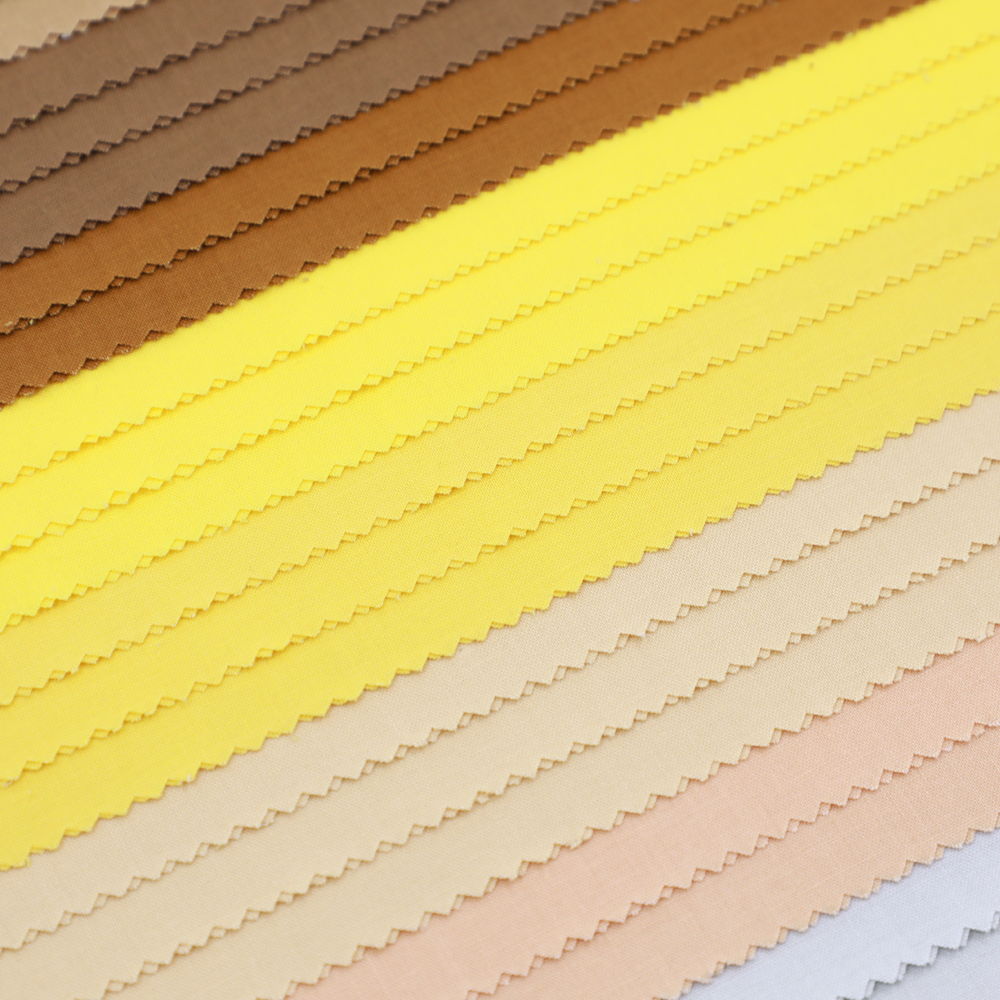Color swatches of fabric in brown, yellow, beige, and pink.