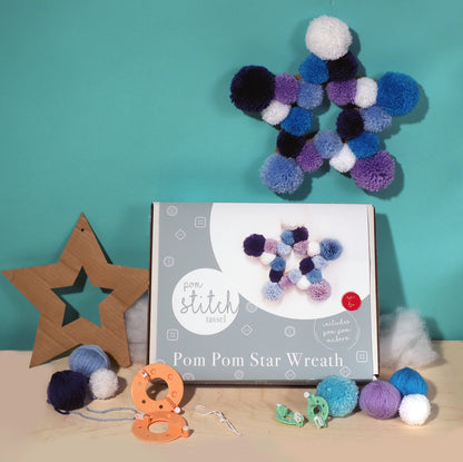 Pom pom star wreath kit with pom poms and tools on a teal background