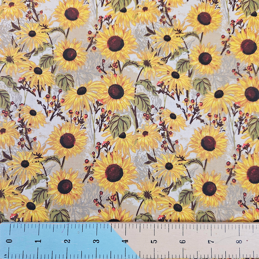 Fabric with sunflower pattern and ruler for scale