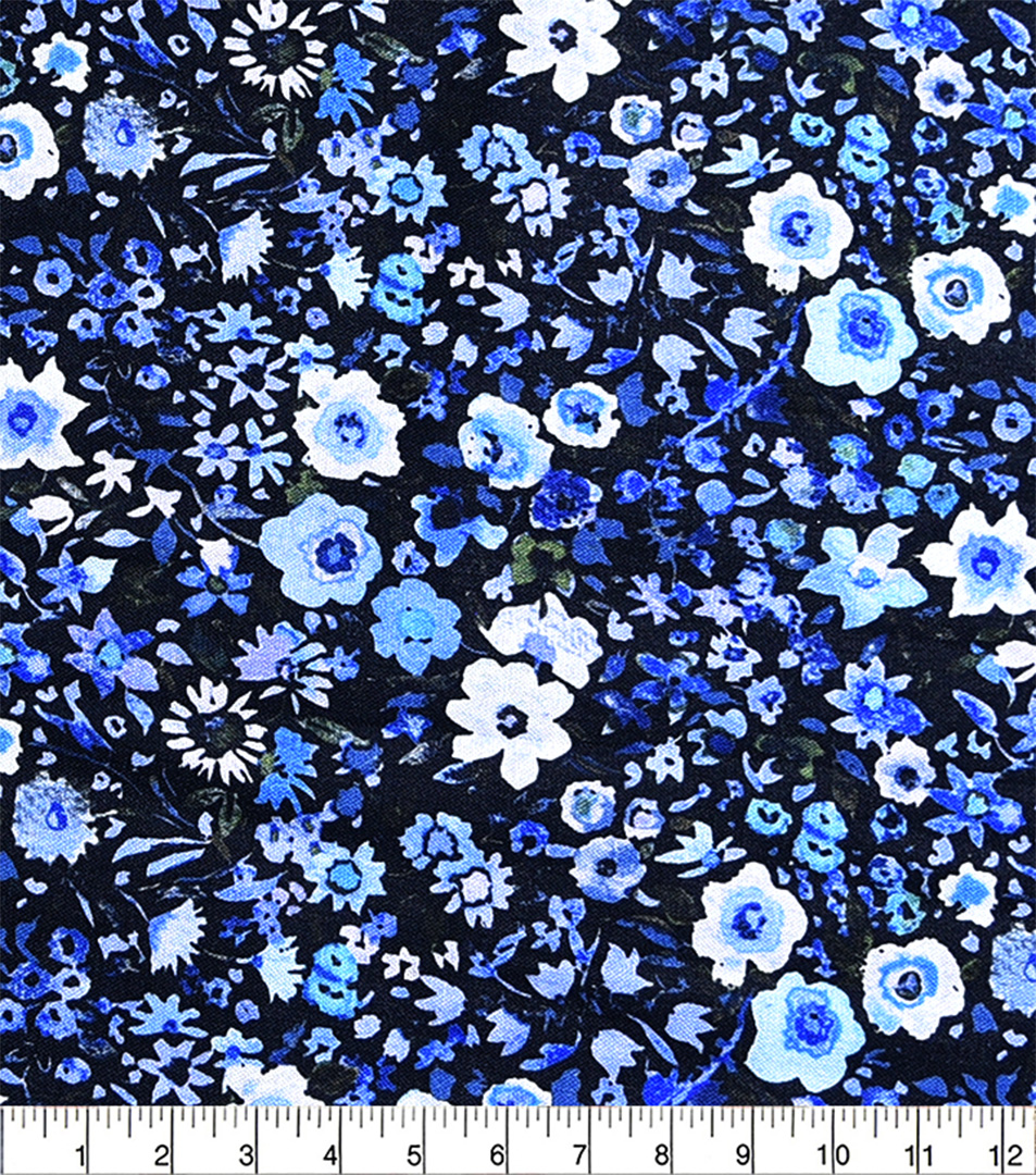 Floral pattern with blue and white flowers on a black background, measured against a ruler.