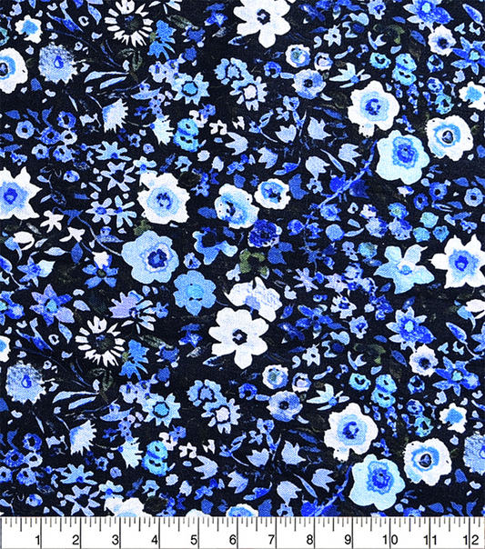 Floral pattern with blue and white flowers on a black background, measured against a ruler.