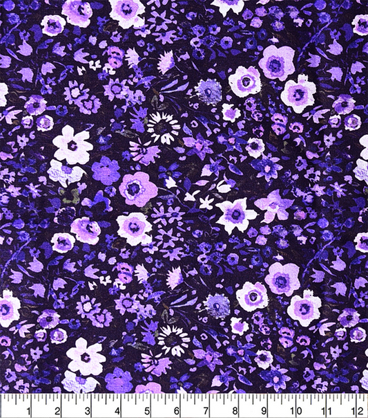 Floral fabric pattern with purple and white flowers on a dark background, measured with a ruler.