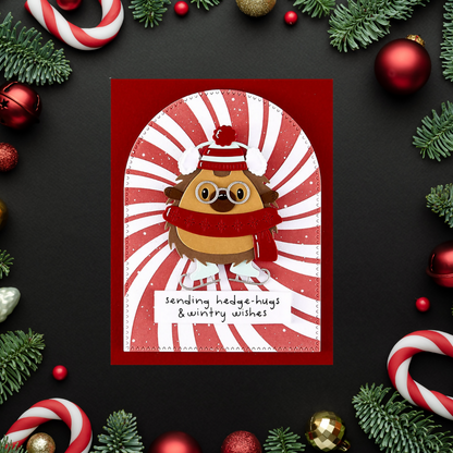 Christmas card with a hedgehog design surrounded by festive decorations on a dark background