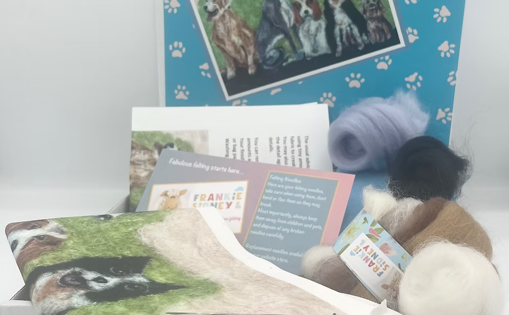 Collection of pet-themed products including a pillow, cards, and a plush toy on a white surface.