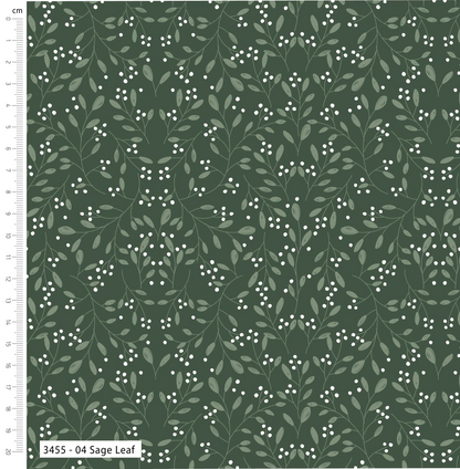 Fabric with leaf pattern on a green background, featuring a ruler for scale.