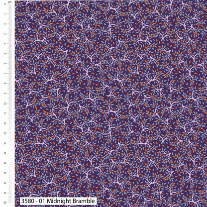Fabric swatch with a pattern of branches and leaves on a purple background, with a ruler for scale.