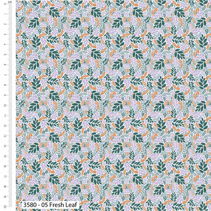Fabric with a leaf pattern and a ruler for scale on the left side.