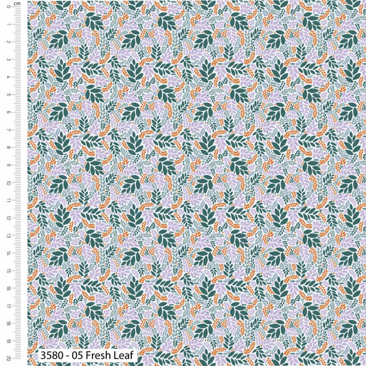 Fabric with a leaf pattern and a ruler for scale on the left side.