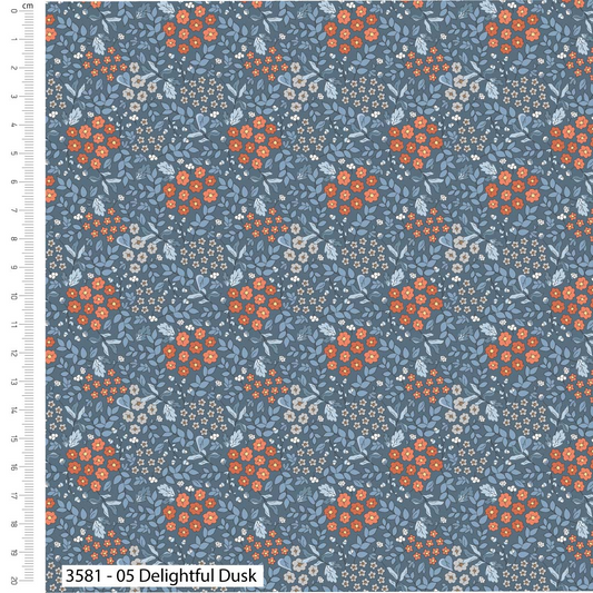 Floral pattern fabric swatch with orange flowers on a blue background, featuring a ruler for scale.