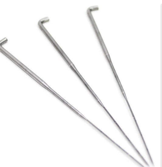 Three metal tent stakes on a white background