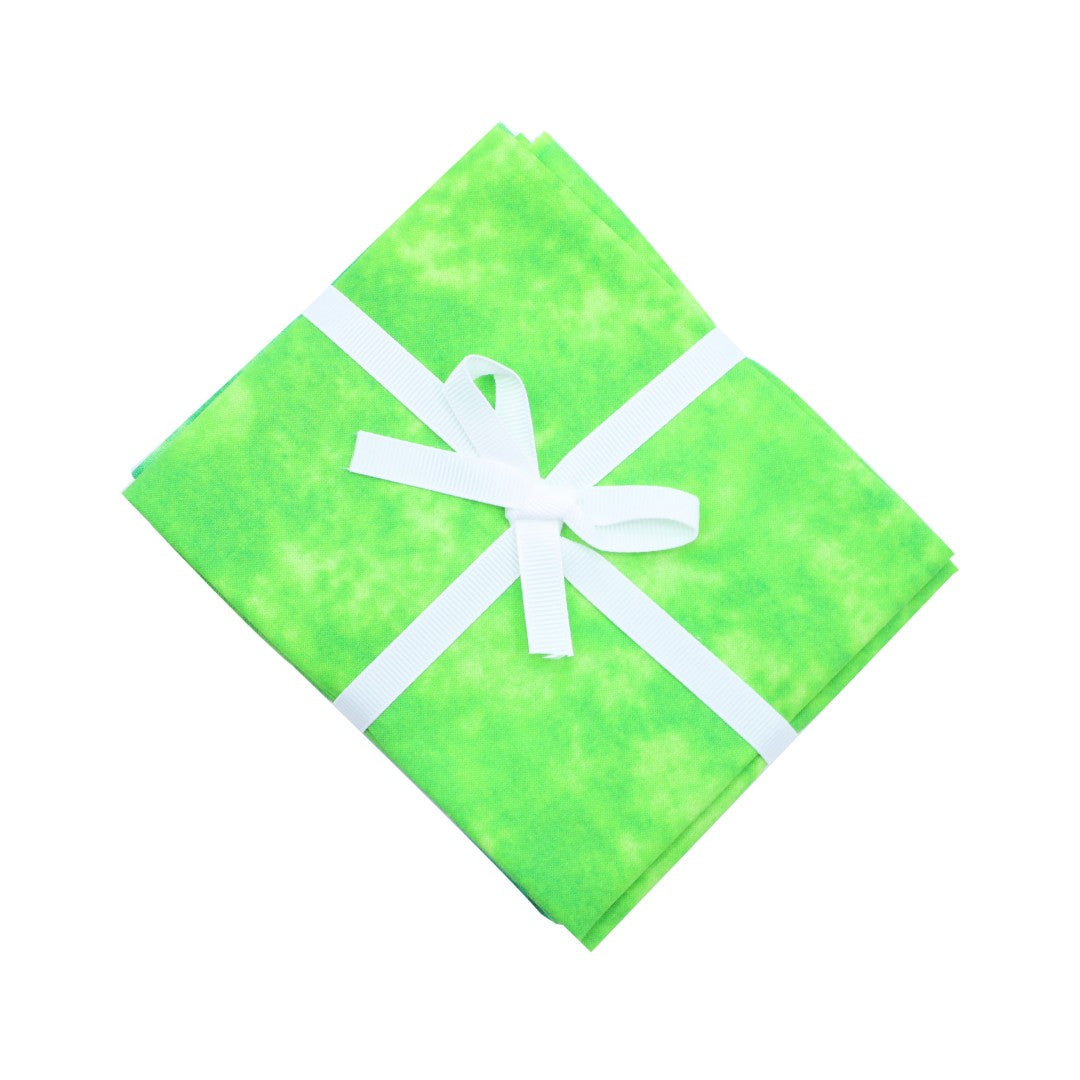 Green fabric with a white bow on a white background
