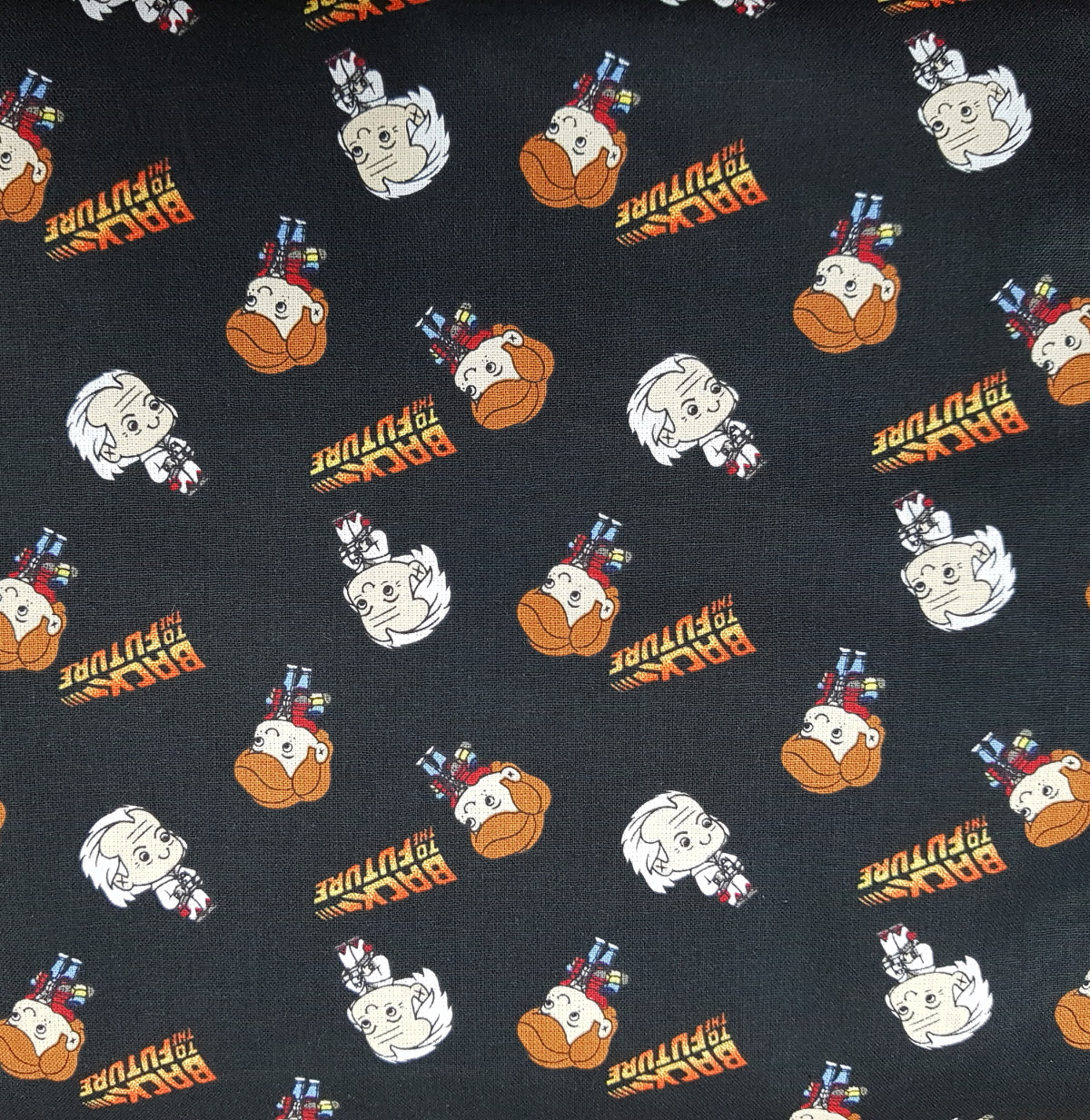Patterned fabric with cartoon characters and text on a black background