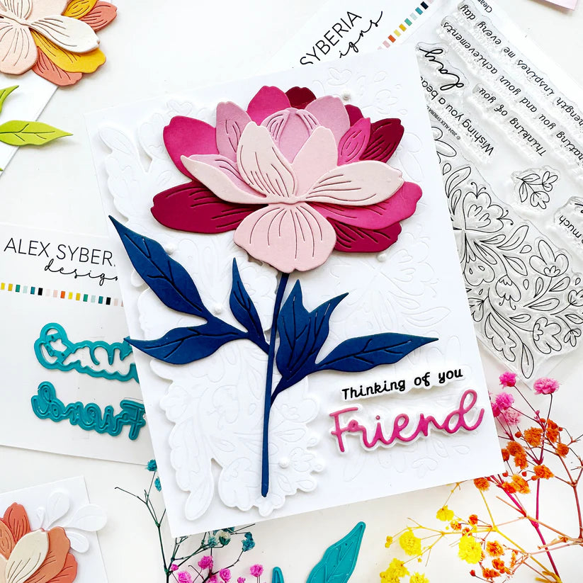 Floral card with 'Thinking of you Friend' text, surrounded by floral designs and stamps.