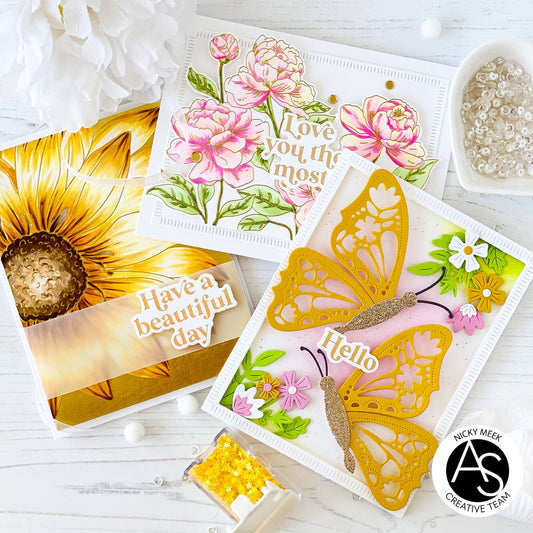 Three decorative greeting cards with floral and butterfly designs on a white surface.