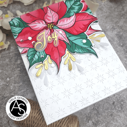 Card with poinsettia design and 'Joy' text on a textured surface