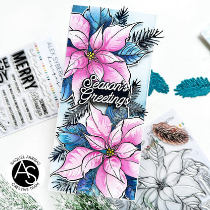Card with pink poinsettias and 'Season's Greetings' text, surrounded by craft materials.