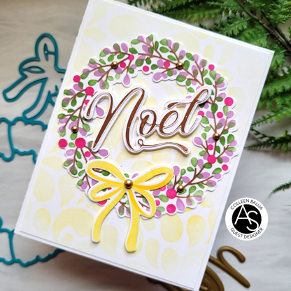 Greeting card with 'Noel' text and floral wreath design on a white background.